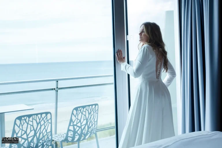mariage le touquet habillage madame regarde la mer au balcon novotel florent studio photographe boulogne sur mer le touquet saint omer lille paris copie